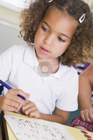To use this stock image in your creative project, please select the size you need over to the right and click the "Add to Cart" button.
Your downloaded image will come with the Cutcaster watermark removed so don’t worry about the watermark you see on this page. Girl learning to write numbers in primary class stock photo, by Monkey Business Images