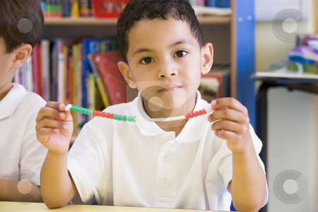 To use this stock image in your creative project, please select the size you need over to the right and click the "Add to Cart" button.
Your downloaded image will come with the Cutcaster watermark removed so don’t worry about the watermark you see on this page. A schoolboy in a primary class stock photo, by Monkey Business Images