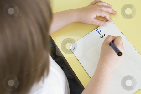 To use this stock image in your creative project, please select the size you need over to the right and click the "Add to Cart" button.
Your downloaded image will come with the Cutcaster watermark removed so don’t worry about the watermark you see on this page. Girl learning to write numbers in primary class stock photo, by Monkey Business Images