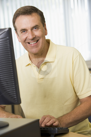To use this stock image in your creative project, please select the size you need over to the right and click the "Add to Cart" button.
Your downloaded image will come with the Cutcaster watermark removed so don’t worry about the watermark you see on this page. Middle aged man working on a computer stock photo, by Monkey Business Images