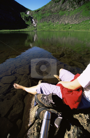 To use this stock image in your creative project, please select the size you need over to the right and click the "Add to Cart" button.
Your downloaded image will come with the Cutcaster watermark removed so don’t worry about the watermark you see on this page. Young woman relaxing on rocks next to lake stock photo, by Monkey Business Images