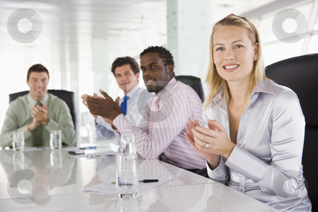 To use this stock image in your creative project, please select the size you need over to the right and click the "Add to Cart" button.
Your downloaded image will come with the Cutcaster watermark removed so don’t worry about the watermark you see on this page. Four businesspeople in a boardroom applauding stock photo, by Monkey Business Images