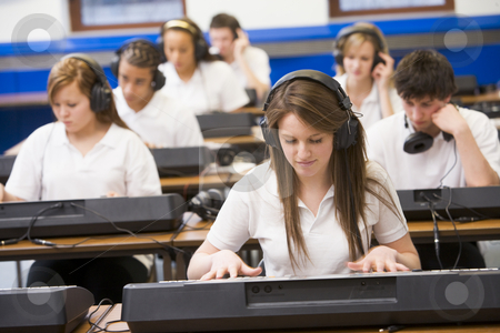 To use this stock image in your creative project, please select the size you need over to the right and click the "Add to Cart" button.
Your downloaded image will come with the Cutcaster watermark removed so don’t worry about the watermark you see on this page. Schoolchildren practicing on a keyboard in music class stock photo, by Monkey Business Images