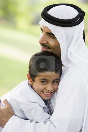 To use this stock image in your creative project, please select the size you need over to the right and click the "Add to Cart" button.
Your downloaded image will come with the Cutcaster watermark removed so don’t worry about the watermark you see on this page. A Middle Eastern man and his son sitting in a park stock photo, by Monkey Business Images