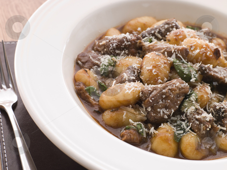 To use this stock image in your creative project, please select the size you need over to the right and click the "Add to Cart" button.
Your downloaded image will come with the Cutcaster watermark removed so don’t worry about the watermark you see on this page. Oxtail Braised in Red Wine with Basil Gnocchi and Parmesan Chees stock photo, by Monkey Business Images