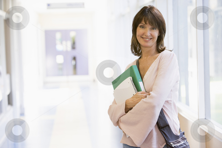 To use this stock image in your creative project, please select the size you need over to the right and click the "Add to Cart" button.
Your downloaded image will come with the Cutcaster watermark removed so don’t worry about the watermark you see on this page. A woman with a backpack standing in a campus corridor stock photo, by Monkey Business Images
