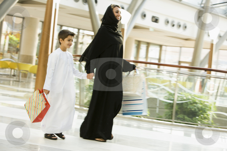 To use this stock image in your creative project, please select the size you need over to the right and click the "Add to Cart" button.
Your downloaded image will come with the Cutcaster watermark removed so don’t worry about the watermark you see on this page. A Middle Eastern woman and her son in a shopping mall stock photo, by Monkey Business Images