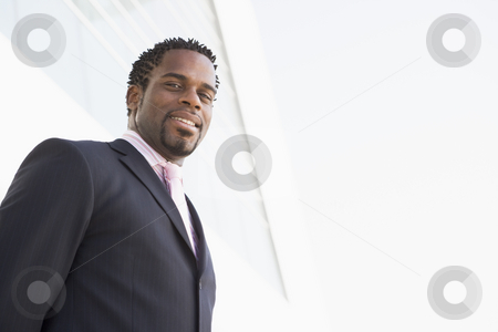 To use this stock image in your creative project, please select the size you need over to the right and click the "Add to Cart" button.
Your downloaded image will come with the Cutcaster watermark removed so don’t worry about the watermark you see on this page. Businessman standing outdoors by building smiling stock photo, by Monkey Business Images