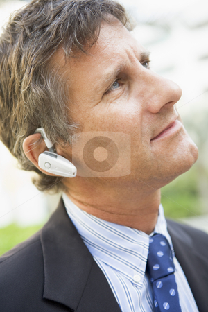 To use this stock image in your creative project, please select the size you need over to the right and click the "Add to Cart" button.
Your downloaded image will come with the Cutcaster watermark removed so don’t worry about the watermark you see on this page. Businessman wearing headset outdoors stock photo, by Monkey Business Images