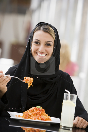 To use this stock image in your creative project, please select the size you need over to the right and click the "Add to Cart" button.
Your downloaded image will come with the Cutcaster watermark removed so don’t worry about the watermark you see on this page. A Middle Eastern woman enjoying a meal in a restaurant stock photo, by Monkey Business Images