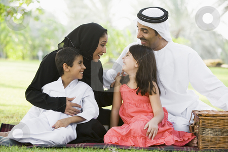 To use this stock image in your creative project, please select the size you need over to the right and click the "Add to Cart" button.
Your downloaded image will come with the Cutcaster watermark removed so don’t worry about the watermark you see on this page. A Middle Eastern family sitting in a park stock photo, by Monkey Business Images