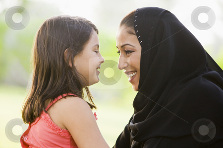 To use this stock image in your creative project, please select the size you need over to the right and click the "Add to Cart" button.
Your downloaded image will come with the Cutcaster watermark removed so don’t worry about the watermark you see on this page. A Middle Eastern woman and her daughter sitting in a park stock photo, by Monkey Business Images