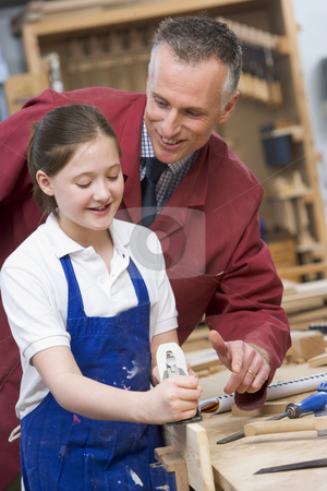 To use this stock image in your creative project, please select the size you need over to the right and click the "Add to Cart" button.
Your downloaded image will come with the Cutcaster watermark removed so don’t worry about the watermark you see on this page. Schoolgirl and teacher in woodwork class stock photo, by Monkey Business Images