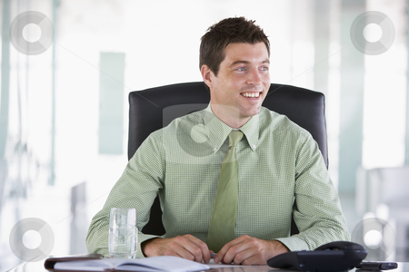 To use this stock image in your creative project, please select the size you need over to the right and click the "Add to Cart" button.
Your downloaded image will come with the Cutcaster watermark removed so don’t worry about the watermark you see on this page. Businessman sitting in office with personal organizer smiling stock photo, by Monkey Business Images