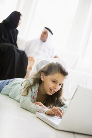 To use this stock image in your creative project, please select the size you need over to the right and click the "Add to Cart" button.
Your downloaded image will come with the Cutcaster watermark removed so don’t worry about the watermark you see on this page. A Middle Eastern girl lying on the floor using a laptop stock photo, by Monkey Business Images