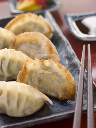 To use this stock image in your creative project, please select the size you need over to the right and click the "Add to Cart" button.
Your downloaded image will come with the Cutcaster watermark removed so don’t worry about the watermark you see on this page. Fried Pork and Shrimp Dumplings with Soy Sauce stock photo, Fried Pork and Shrimp Dumplings on a dish with Soy Sauce and chopsticks by Monkey Business Images