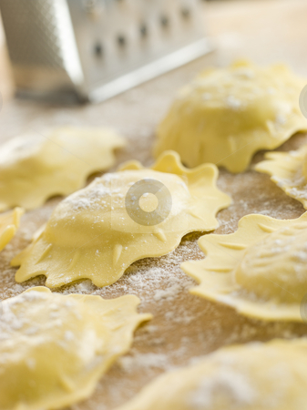 To use this stock image in your creative project, please select the size you need over to the right and click the "Add to Cart" button.
Your downloaded image will come with the Cutcaster watermark removed so don’t worry about the watermark you see on this page. Uncooked Spinach and Ricotta Ravioli on a floured surface stock photo, Close up of Uncooked Spinach and Ricotta Ravioli on a floured surface by Monkey Business Images