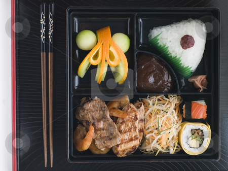 To use this stock image in your creative project, please select the size you need over to the right and click the "Add to Cart" button.
Your downloaded image will come with the Cutcaster watermark removed so don’t worry about the watermark you see on this page. Teppanyaki Lunchbox with Chopsticks stock photo, Overhead shot of Teppanyaki Lunchbox with Chopsticks by Monkey Business Images