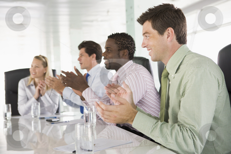 To use this stock image in your creative project, please select the size you need over to the right and click the "Add to Cart" button.
Your downloaded image will come with the Cutcaster watermark removed so don’t worry about the watermark you see on this page. Four businesspeople in a boardroom applauding stock photo, by Monkey Business Images