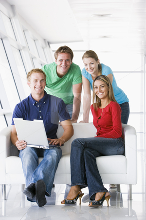 To use this stock image in your creative project, please select the size you need over to the right and click the "Add to Cart" button.
Your downloaded image will come with the Cutcaster watermark removed so don’t worry about the watermark you see on this page. Four people in lobby with laptop smiling stock photo, by Monkey Business Images