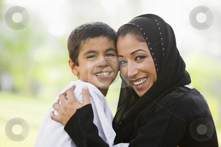 To use this stock image in your creative project, please select the size you need over to the right and click the "Add to Cart" button.
Your downloaded image will come with the Cutcaster watermark removed so don’t worry about the watermark you see on this page. A Middle Eastern woman and her son sitting in a park stock photo, by Monkey Business Images