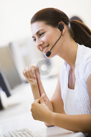 To use this stock image in your creative project, please select the size you need over to the right and click the "Add to Cart" button.
Your downloaded image will come with the Cutcaster watermark removed so don’t worry about the watermark you see on this page. Woman wearing headset in computer room smiling stock photo, by Monkey Business Images