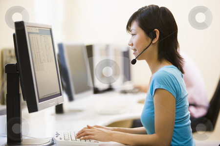 To use this stock image in your creative project, please select the size you need over to the right and click the "Add to Cart" button.
Your downloaded image will come with the Cutcaster watermark removed so don’t worry about the watermark you see on this page. Woman wearing headset in computer room typing and smiling stock photo, by Monkey Business Images