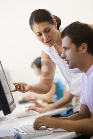 To use this stock image in your creative project, please select the size you need over to the right and click the "Add to Cart" button.
Your downloaded image will come with the Cutcaster watermark removed so don’t worry about the watermark you see on this page. Woman assisting man in computer room stock photo, by Monkey Business Images