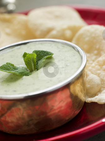 To use this stock image in your creative project, please select the size you need over to the right and click the "Add to Cart" button.
Your downloaded image will come with the Cutcaster watermark removed so don’t worry about the watermark you see on this page. Fresh Green Yoghurt Chutney with mini Papadoms stock photo, Plate of Fresh Green Yoghurt Chutney with mini Papadoms by Monkey Business Images