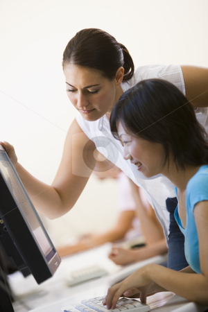 To use this stock image in your creative project, please select the size you need over to the right and click the "Add to Cart" button.
Your downloaded image will come with the Cutcaster watermark removed so don’t worry about the watermark you see on this page. Two women in computer room where one is assisting the other stock photo, by Monkey Business Images