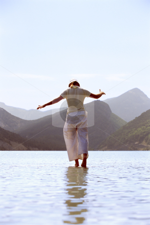 To use this stock image in your creative project, please select the size you need over to the right and click the "Add to Cart" button.
Your downloaded image will come with the Cutcaster watermark removed so don’t worry about the watermark you see on this page. Young woman walking in lake stock photo, by Monkey Business Images