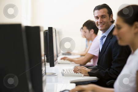 To use this stock image in your creative project, please select the size you need over to the right and click the "Add to Cart" button.
Your downloaded image will come with the Cutcaster watermark removed so don’t worry about the watermark you see on this page. Four people in computer room with one man wearing a suit smiling stock photo, by Monkey Business Images