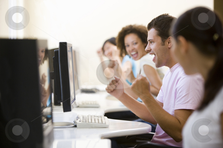 To use this stock image in your creative project, please select the size you need over to the right and click the "Add to Cart" button.
Your downloaded image will come with the Cutcaster watermark removed so don’t worry about the watermark you see on this page. Four people in computer room cheering and smiling stock photo, by Monkey Business Images