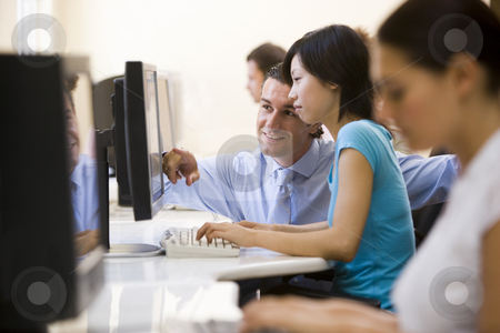 To use this stock image in your creative project, please select the size you need over to the right and click the "Add to Cart" button.
Your downloaded image will come with the Cutcaster watermark removed so don’t worry about the watermark you see on this page. Man assisting woman in computer room smiling stock photo, by Monkey Business Images