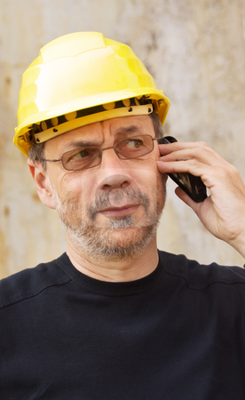 To use this stock image in your creative project, please select the size you need over to the right and click the "Add to Cart" button.
Your downloaded image will come with the Cutcaster watermark removed so don’t worry about the watermark you see on this page. Yellow hard hat stock photo, Mature man in yellow hard hat speaking on mobile phone by Mikhail Lavrenov