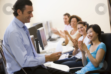 To use this stock image in your creative project, please select the size you need over to the right and click the "Add to Cart" button.
Your downloaded image will come with the Cutcaster watermark removed so don’t worry about the watermark you see on this page. Man with clipboard giving lecture in applauding computer class stock photo, by Monkey Business Images