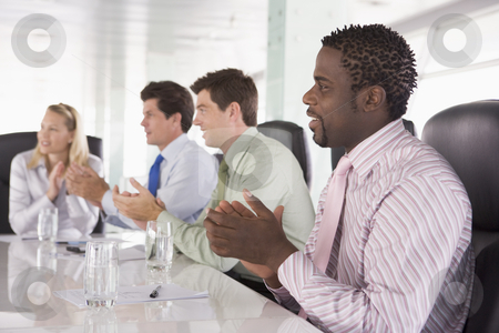 To use this stock image in your creative project, please select the size you need over to the right and click the "Add to Cart" button.
Your downloaded image will come with the Cutcaster watermark removed so don’t worry about the watermark you see on this page. Four businesspeople in a boardroom applauding stock photo, by Monkey Business Images
