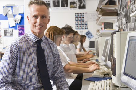 To use this stock image in your creative project, please select the size you need over to the right and click the "Add to Cart" button.
Your downloaded image will come with the Cutcaster watermark removed so don’t worry about the watermark you see on this page. Teacher and schoolchildren studying in front of a computer stock photo, by Monkey Business Images