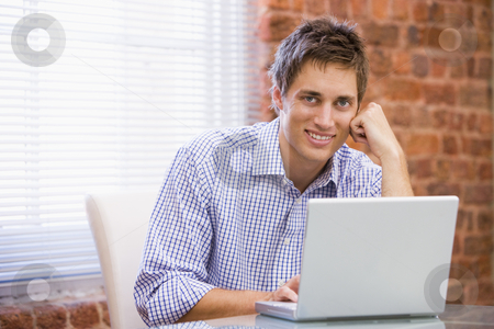 To use this stock image in your creative project, please select the size you need over to the right and click the "Add to Cart" button.
Your downloaded image will come with the Cutcaster watermark removed so don’t worry about the watermark you see on this page. Businessman sitting in office with laptop smiling stock photo, by Monkey Business Images