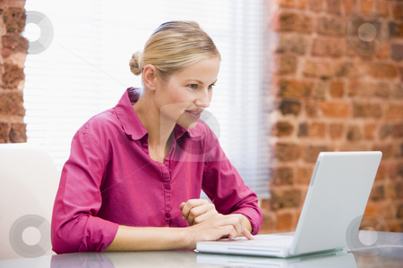 To use this stock image in your creative project, please select the size you need over to the right and click the "Add to Cart" button.
Your downloaded image will come with the Cutcaster watermark removed so don’t worry about the watermark you see on this page. Businesswoman sitting in office using laptop smiling stock photo, by Monkey Business Images