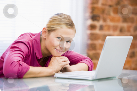 To use this stock image in your creative project, please select the size you need over to the right and click the "Add to Cart" button.
Your downloaded image will come with the Cutcaster watermark removed so don’t worry about the watermark you see on this page. Businesswoman sitting in office with laptop smiling stock photo, by Monkey Business Images