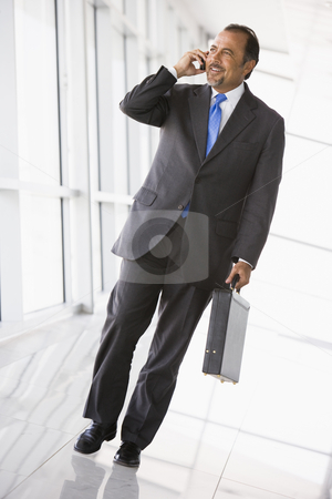 To use this stock image in your creative project, please select the size you need over to the right and click the "Add to Cart" button.
Your downloaded image will come with the Cutcaster watermark removed so don’t worry about the watermark you see on this page. Businessman talking on mobile phone in lobby stock photo, Businessman talking on mobile phone in office lobby by Monkey Business Images