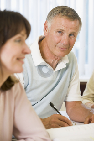 To use this stock image in your creative project, please select the size you need over to the right and click the "Add to Cart" button.
Your downloaded image will come with the Cutcaster watermark removed so don’t worry about the watermark you see on this page. Senior man studying with other adult students stock photo, by Monkey Business Images