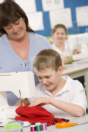 To use this stock image in your creative project, please select the size you need over to the right and click the "Add to Cart" button.
Your downloaded image will come with the Cutcaster watermark removed so don’t worry about the watermark you see on this page. Teacher and schoolboy using a sewing machine in sewing class stock photo, by Monkey Business Images