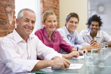 To use this stock image in your creative project, please select the size you need over to the right and click the "Add to Cart" button.
Your downloaded image will come with the Cutcaster watermark removed so don’t worry about the watermark you see on this page. Four businesspeople in boardroom smiling stock photo, by Monkey Business Images