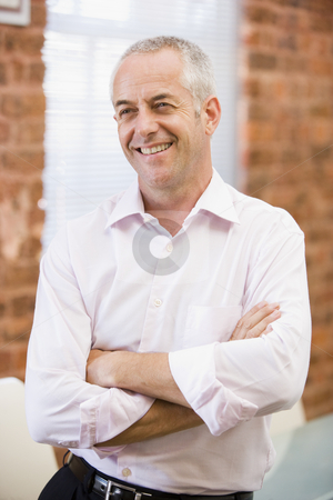To use this stock image in your creative project, please select the size you need over to the right and click the "Add to Cart" button.
Your downloaded image will come with the Cutcaster watermark removed so don’t worry about the watermark you see on this page. Businessman sitting in office space smiling stock photo, by Monkey Business Images