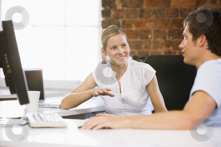 To use this stock image in your creative project, please select the size you need over to the right and click the "Add to Cart" button.
Your downloaded image will come with the Cutcaster watermark removed so don’t worry about the watermark you see on this page. Two businesspeople in office talking and smiling stock photo, by Monkey Business Images