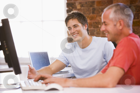 To use this stock image in your creative project, please select the size you need over to the right and click the "Add to Cart" button.
Your downloaded image will come with the Cutcaster watermark removed so don’t worry about the watermark you see on this page. Two businessmen in office typing on computer and smiling stock photo, by Monkey Business Images