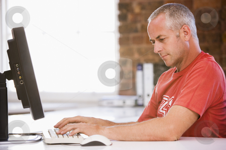 To use this stock image in your creative project, please select the size you need over to the right and click the "Add to Cart" button.
Your downloaded image will come with the Cutcaster watermark removed so don’t worry about the watermark you see on this page. Businessman in office typing on computer stock photo, by Monkey Business Images