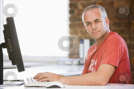 To use this stock image in your creative project, please select the size you need over to the right and click the "Add to Cart" button.
Your downloaded image will come with the Cutcaster watermark removed so don’t worry about the watermark you see on this page. Businessman in office typing on computer stock photo, by Monkey Business Images